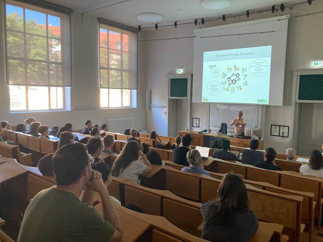 A group of people in a lecture hall
AI-generated content may be incorrect.